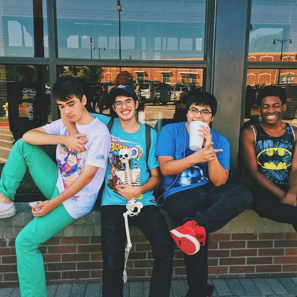 Group of diverse teenagers sitting in a circle and meditating.